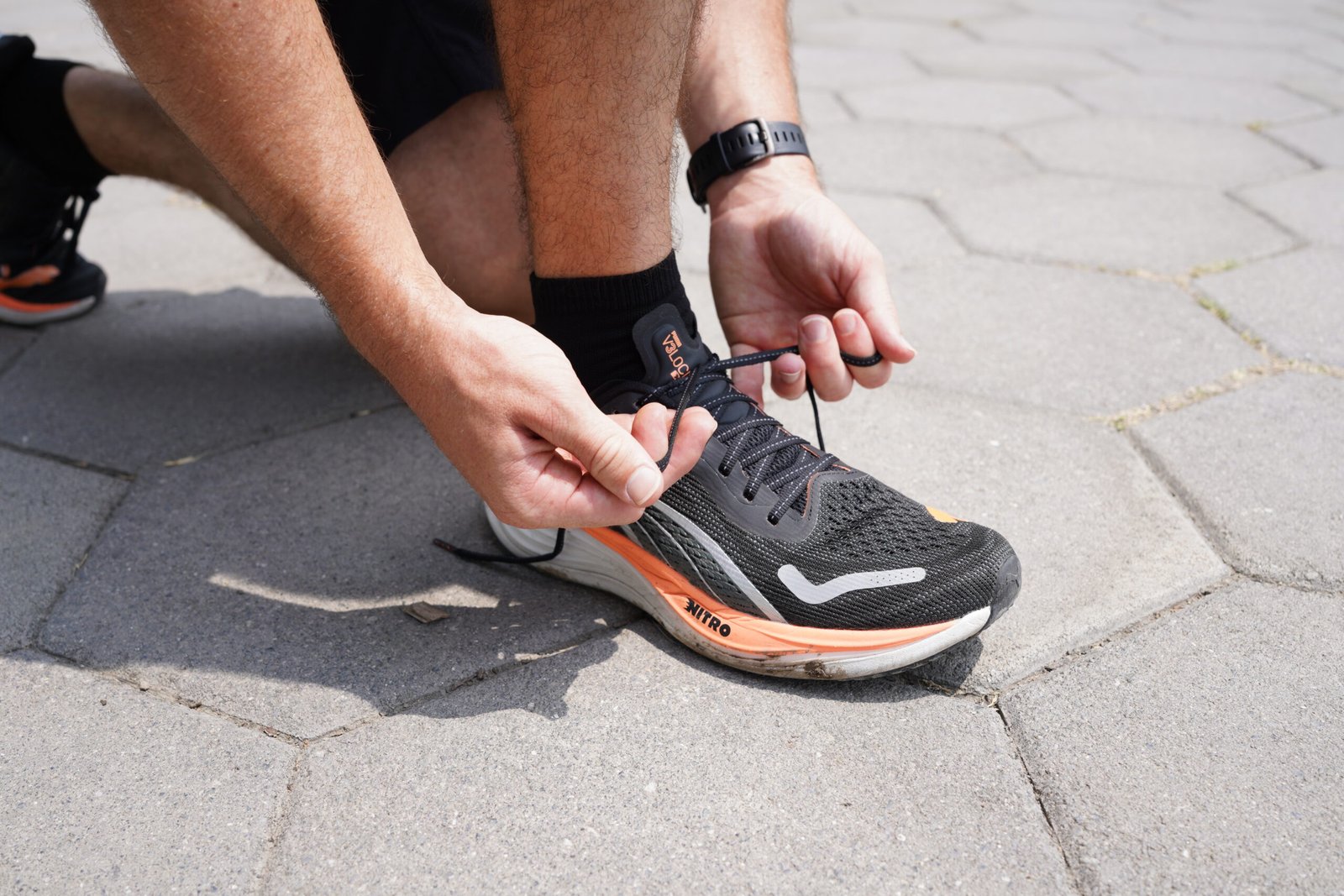 Beginner runner lacing up Puma Velocity Nitro 3 shoes