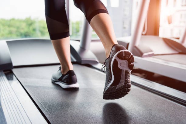 Close up of a runner's feet on a treadmill belt